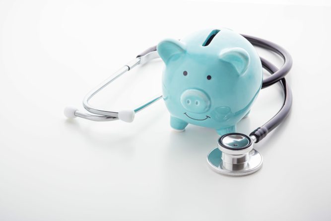 Piggy bank with stethoscope on white table, health saving account, hsa concept