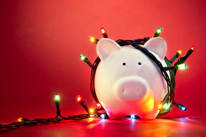 Piggy bank wrapped in Christmas string lights