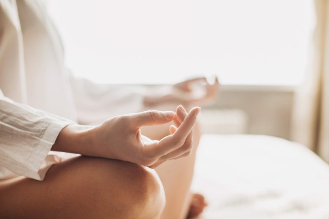 Yoga woman meditating and practicing yoga at home. Recreation, self care, yoga training, fitness, breathing exercises, meditation, relaxation, healthy lifestyle concept